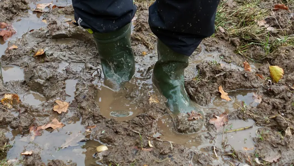 Green boots stuck in mud