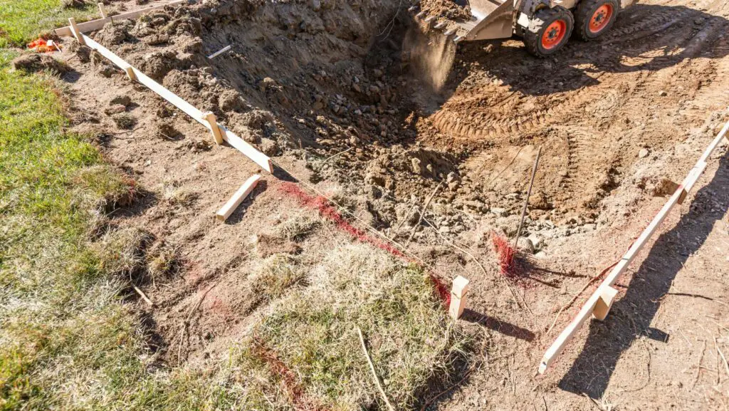 tractor removing rocks stuck in a garden